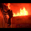 photograph of a firefighter down a ladder