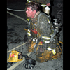 an exhausted firefighter takes a breather