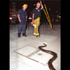 photograph of firefighters with snake